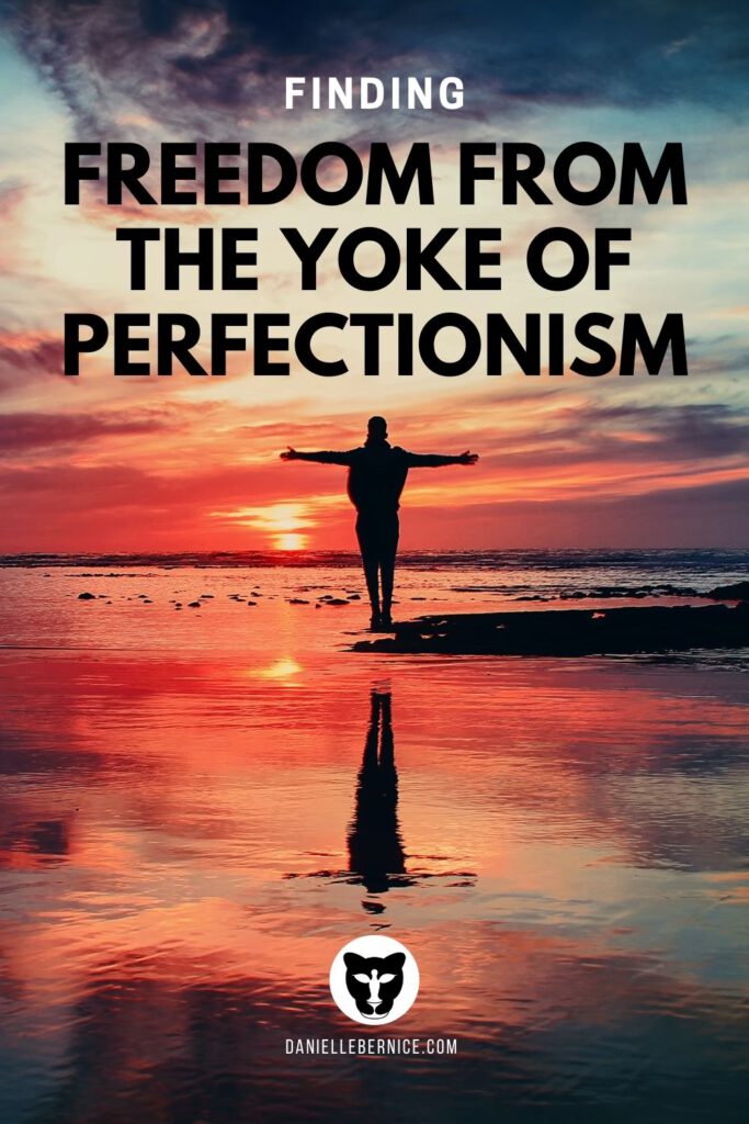 Man standing in the sunrise with his arms stretched wide - Finding freedeom from the yoke of perfectionism