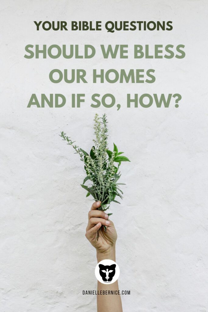 A photo of a hand holding up a variety of herbs in front of a white washed wall. The text says: Your Bible Questions - Should we bless our home and if so, how?